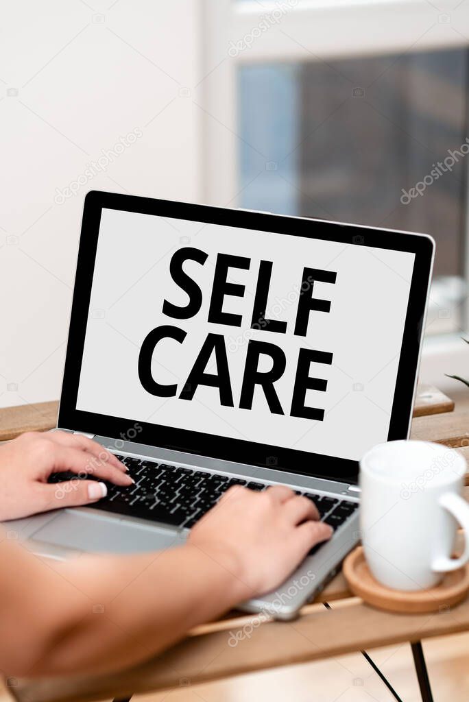 Handwriting text Self Care. Word for practice of taking action preserve or improve ones own health Both Hands Typing On Laptop Next To Cup And Plant Working From Home.