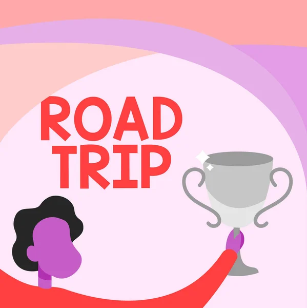 Conceptual display Road Trip. Word Written on long distance journey on the road traveled by automobile Man Holding Trophy Cup Up High Celebrating Victory Achievement. — Stock Photo, Image