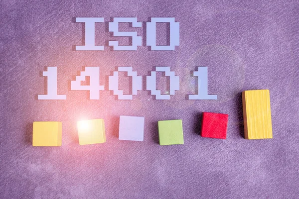 Writing displaying text Iso 14001. Conceptual photo a family of standards related to environmental management Stack of Sample Cube Rectangular Boxes On Surface Polished With Multi-Colour — Stock Photo, Image
