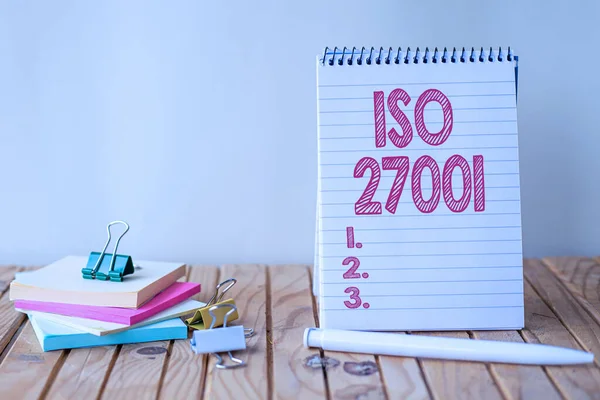 Handwriting text Iso 27001. Conceptual photo specification for an information security management system Empty Spiral Notepad With Pen Beside Stockpile Of Sticky Notes. — Stock Photo, Image