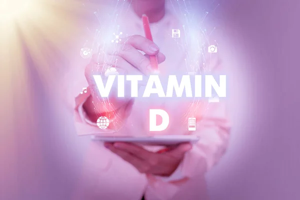 Bildunterschrift: Großansicht des Bildes mit der Bildunterschrift: Vitamin D - Nährstoff, der für die Steigerung der Darmresorption verantwortlich ist Geschäftsfrau benutzt Telefon und präsentiert neues futuristisches virtuelles Display. — Stockfoto