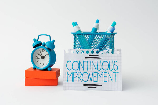 Text caption presenting Continuous Improvement. Concept meaning Ongoing Effort to Advance Never ending changes Tidy Workspace Setup Writing Desk Tools And Equipment Time Management