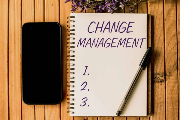 Text showing inspiration Change Management. Word for Replacement of leadership in an organization New Policies Empty Open Journal Beside Mobile With Pens On Top Of Wooden Desk. — Stock Photo, Image