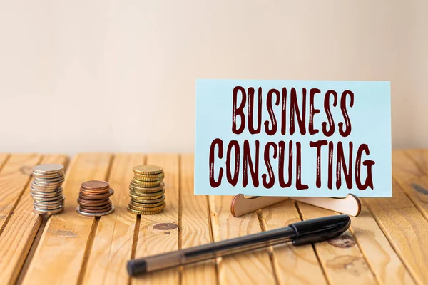 Έμπνευση δείχνει σημάδι Business Consulting. Επιχειρηματική προσέγγιση Συνδυάζει Πρακτική της Ακαδημαϊκής Θεωρητικής Εμπειρογνωμοσύνης Άδειο κομμάτι του χαρτιού για τον κάτοχο δίπλα στα κέρματα σωρός πάνω από το γραφείο με στυλό. — Φωτογραφία Αρχείου