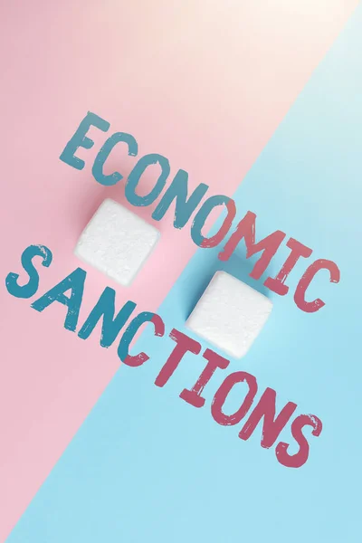 Text showing inspiration Economic Sanctions. Conceptual photo Penalty Punishment levied on another country Trade war Two Objects Arranged Facing Inward Outward On a Separated Coloured Background — Stock Photo, Image