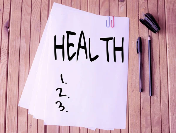 Conceptual caption Health. Word Written on condition of the body and the degree to which it is free from illness Office Stationery Paper Clipped Together Laying Flat On Table. — Stock Photo, Image
