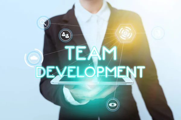 Text caption presenting Team Development. Business idea learn why and how small groups change over time with graphs Woman In Suit Standing Using Device Showing New Futuristic Virtual Tech. — Stock Photo, Image