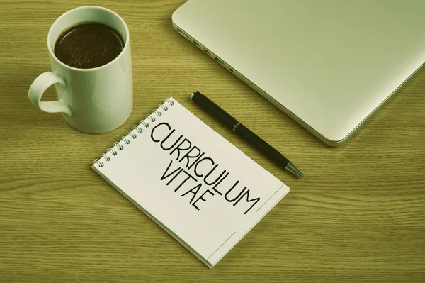 Text sign showing Curriculum Vitae. Word for overview of person qualifications for job opportunity Closed Laptop Beside Empty Journal With Pen And Coffee Mug Over Table. — Stock Photo, Image