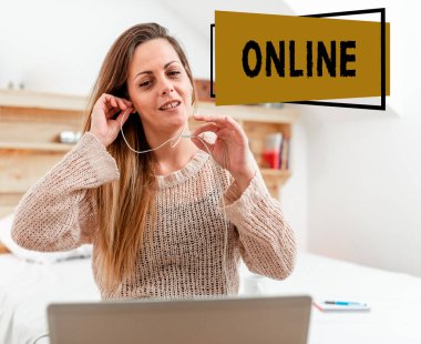 Çevrimiçi işareti gösteren bir ilham. Bir ağa bağlı bilgisayar ya da aygıt için sözcük ve kablolu kulaklıkla yatak odasından bilgisayara vediocall yapan kadını kullanmaya hazır