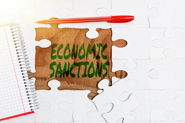 Conceptual display Economic Sanctions. Concept meaning Penalty Punishment levied on another country Trade war Building An Unfinished White Jigsaw Pattern Puzzle With Missing Last Piece — Stock Photo, Image
