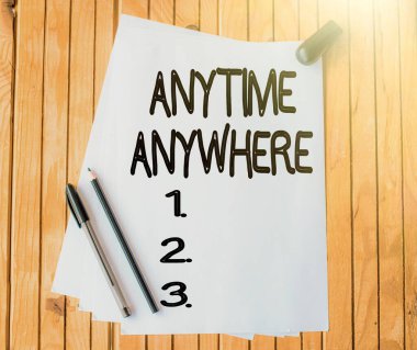 Her zaman, her yerde gösteren bir tabela. İnternet Konsepti, her an, her yerde bir şeyler yapabileceğinizi söylüyor Ofis Kağıdı Bir arada Açılmış Masanın üzerine.
