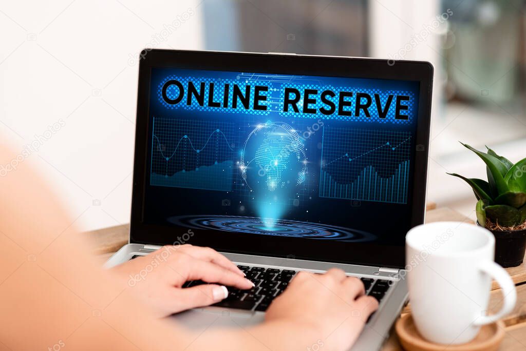 Conceptual display Online Reserve. Business concept enables the customers to book by checking availability Hand Typing On Laptop Next To Coffee Mug And Plant Working From Home.