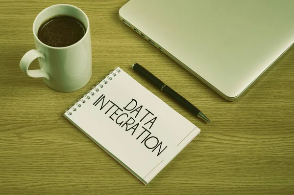 Conceptual display Data Integration. Business approach combination of technical and business processes to combine Closed Laptop Beside Empty Journal With Pen And Coffee Mug Over Table. — 图库照片