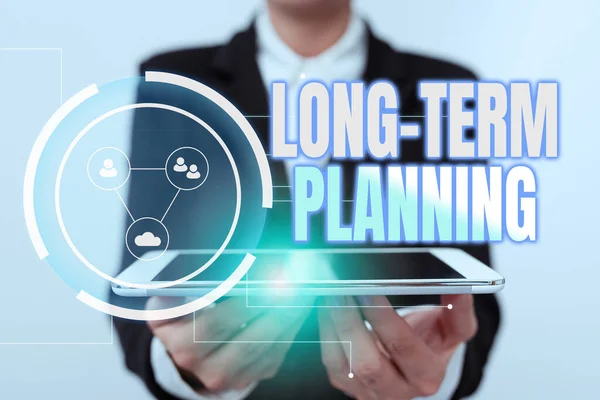 Text sign showing Long Term Planning. Business concept Establish Expected Goals five or more years ahead Lady In Uniform Holding Touchpad Showing Futuristic Virtual Interface. — Stockfoto