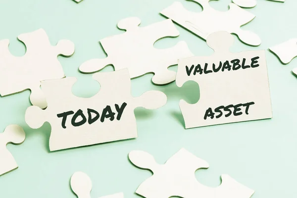 Handwriting text Valuable Asset. Business concept Your most valuable asset is your ability or capacity Building An Unfinished White Jigsaw Pattern Puzzle With Missing Last Piece — Stock Photo, Image