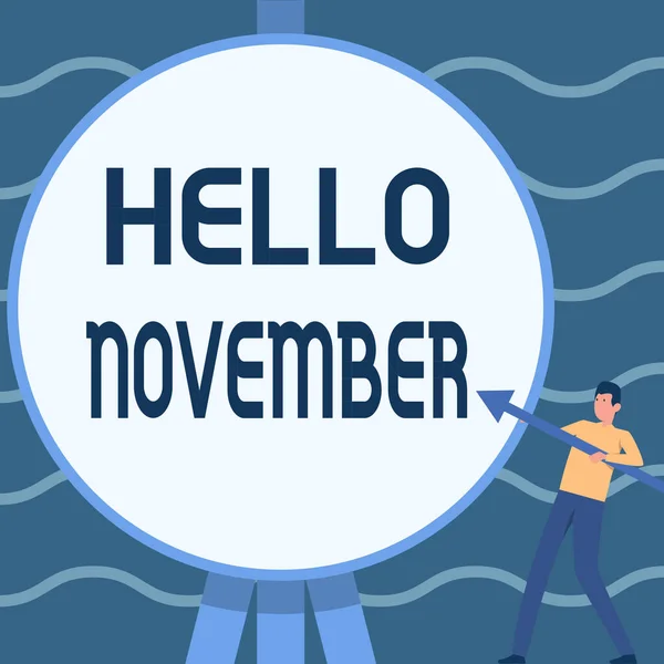 Tekst bijschrift met Hallo November. Business idee begroeting gebruikt bij het verwelkomen van de elfde maand van het jaar Man Staande Holding Grote Pijl Wijzen naar Grote Circulaire Doelstelling. — Stockfoto