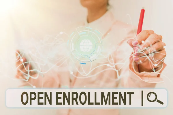 Writing displaying text Open Enrollment. Business approach The yearly period when showing can enroll an insurance Lady In Uniform Using Futuristic Mobile Holographic Display Screen. — Stockfoto