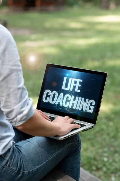 Text showing inspiration Life Coaching. Business approach Improve Lives by Challenges Encourages us in our Careers Woman Typing On Laptop Sitting Outside Side View Working From Home.