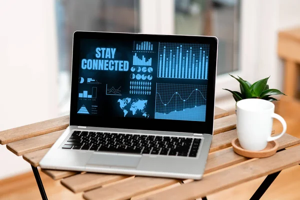 Handwriting text Stay Connected. Business approach to remain having social professional commercial relationship Laptop Resting On A Table Beside Coffee Mug And Plant Showing Work Process. — Stockfoto