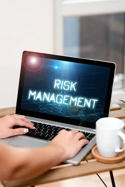Conceptual display Risk Management. Word for assessing and controlling future threats to the business Both Hands Typing On Laptop Next To Cup And Plant Working From Home. — Stockfoto