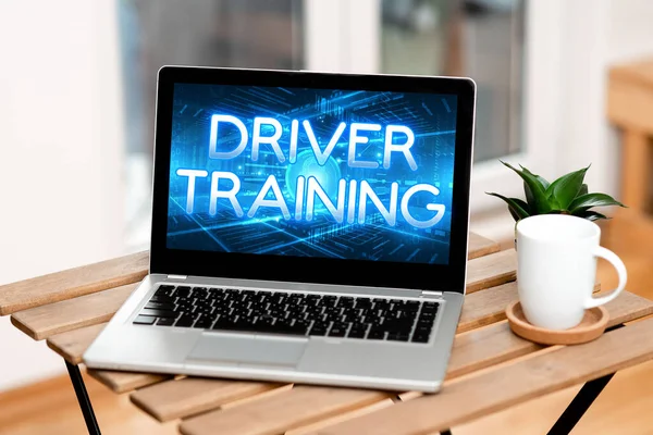 Handwriting text Driver Training. Conceptual photo prepares a new driver to obtain a driver s is license Laptop Resting On A Table Beside Coffee Mug And Plant Showing Work Process. — Stockfoto