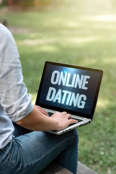 Text showing inspiration Online Dating. Business idea Searching Matching Relationships eDating Video Chatting Woman Typing On Laptop Sitting Outside Side View Working From Home. — Stock Photo, Image