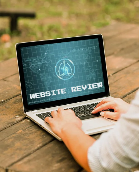 Text showing inspiration Website Review. Word Written on Reviews that can be posted about businesses and services Laptop Placed Resting On Table Working In The Park Doing Remote Jobs. — Stock Photo, Image