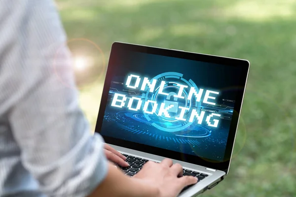 Hand writing sign Online Booking. Conceptual photo Reservation through internet Hotel accommodation Plane ticket Woman Typing On Laptop In The Park Alone Accomplishing Remote Jobs. — Fotografia de Stock