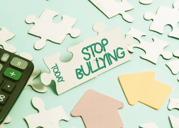 Hand writing sign Stop Bullying. Business showcase Fight and Eliminate this Aggressive Unacceptable Behavior Building An Unfinished White Jigsaw Pattern Puzzle With Missing Last Piece — 图库照片