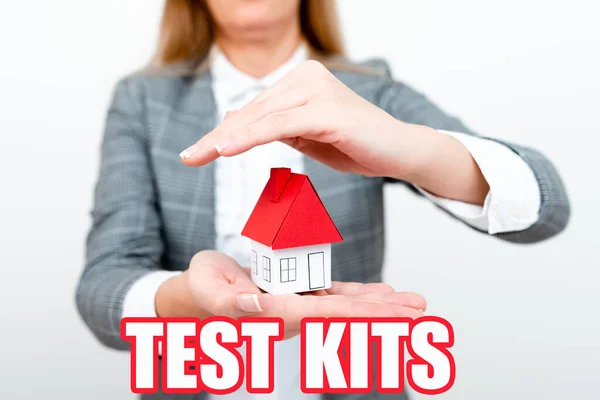 Text sign showing Test Kits. Word Written on tools used to detect the presence of something in the body A Young Lady Orbusinesswoman Holding Orpresenting Home In Business Outfit — Fotografia de Stock
