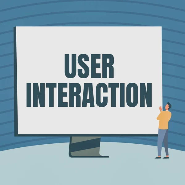 Schreiben von Text User Interaction. Word Written on how the customer acts on the system and vice versa Man Standing Drawing Looking At Large Monitor Display Showing News. — Stockfoto
