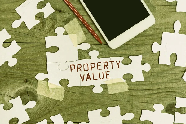 Hand writing sign Property Value. Business approach Worth of a land Real estate appraisal Fair market price Building An Unfinished White Jigsaw Pattern Puzzle With Missing Last Piece — Foto Stock