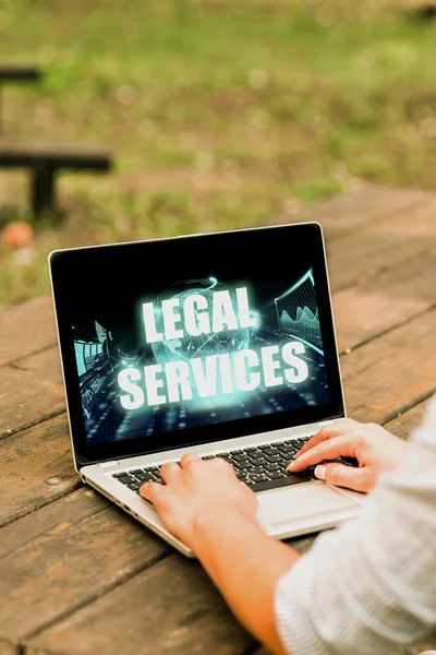 Text caption presenting Legal Services. Internet Concept Providing access to justice Fair trial Law equality Laptop Placed Resting On Table Working In The Park Doing Remote Jobs. — стоковое фото