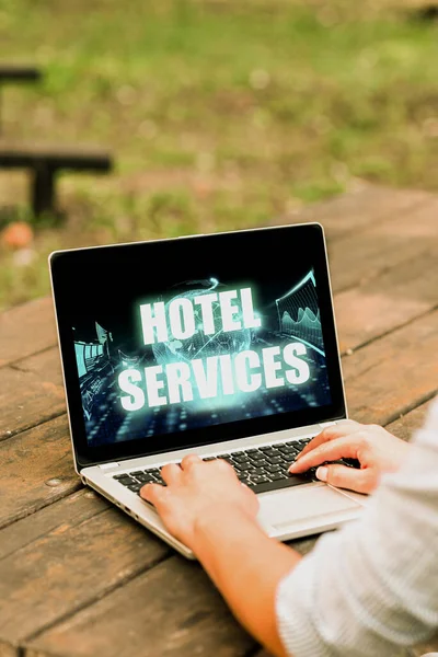 Text sign showing Hotel Services. Business overview Facilities Amenities of an accommodation and lodging house Laptop Placed Resting On Table Working In The Park Doing Remote Jobs. — Stockfoto