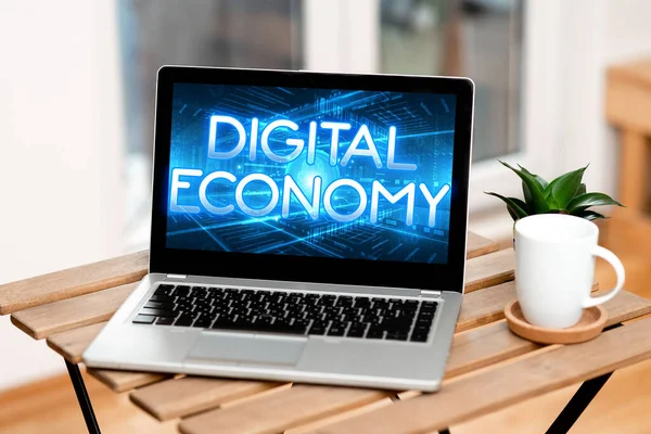 Text sign showing Digital Economy. Business approach worldwide network of economic activities and technologies Laptop Resting On A Table Beside Coffee Mug And Plant Showing Work Process. — Stockfoto