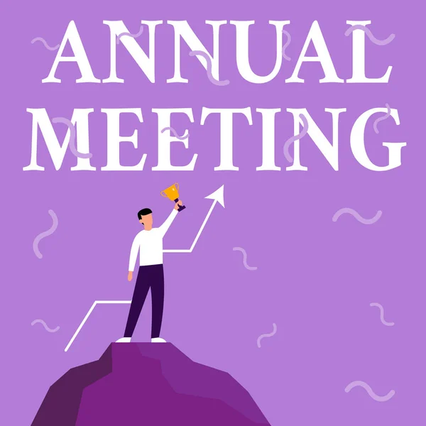 Handwriting text Annual Meeting. Conceptual photo scheduled annually for the discussion of the business future Businessman Drawing Standing On Big Rock Proudly Holding Trophy. — Stockfoto