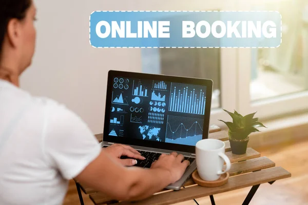 Inspiration showing sign Online Booking. Business showcase allows consumers to reserve for activity through the website Woman Doing Work On Laptop Next To Plant And Mug Working From Home. — Fotografia de Stock