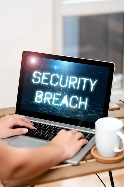 Text sign showing Security Breach. Business showcase unauthorized access of data gained by a malicious intruder Both Hands Typing On Laptop Next To Cup And Plant Working From Home. — Stock Fotó