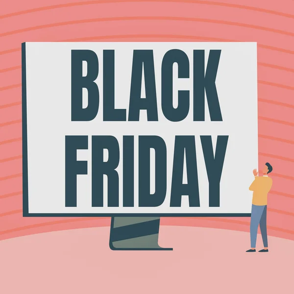 Conceptual caption Black Friday. Concept meaning a day where seller mark their prices down exclusively for buyer Man Standing Drawing Looking At Large Monitor Display Showing News. — Stock Photo, Image