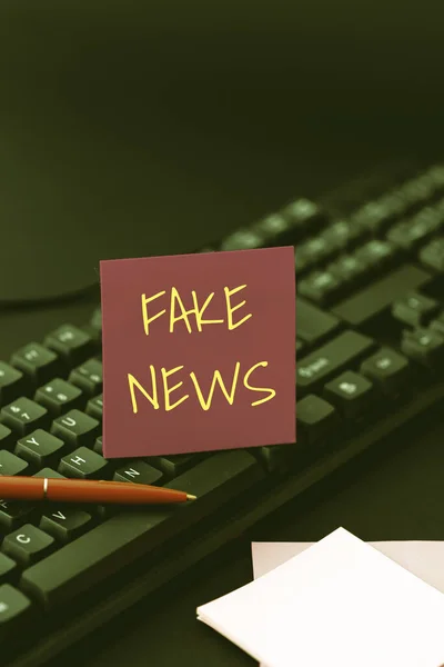 Handwriting text Fake News. Business idea false information publish under the guise of being authentic news Creating Computer Programming Services, Typing New Worksheet Data