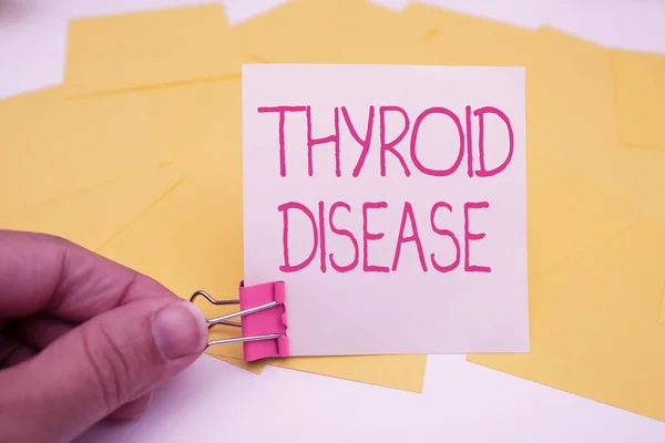 Handwriting text Thyroid Disease. Conceptual photo the thyroid gland fails to produce enough hormones Office Supplies Over Desk With Keyboard And Glasses And Coffee Cup For Working