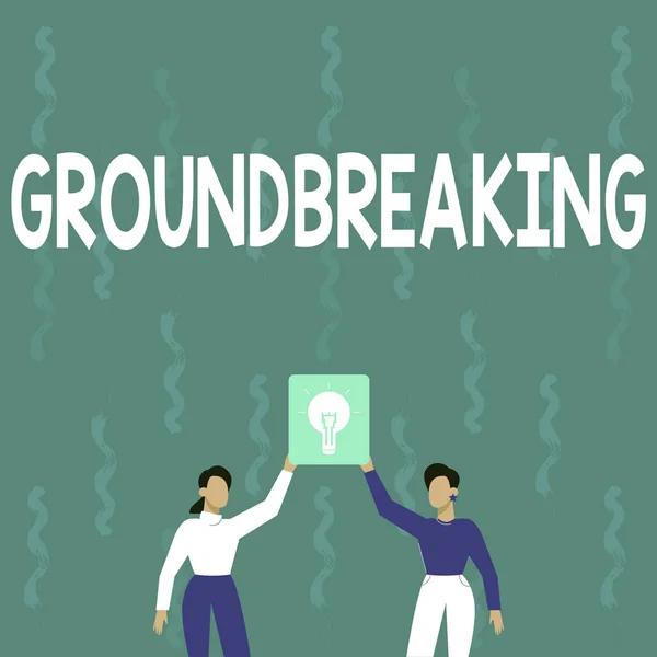 Sign displaying Ground Breaking. Business overview Very new and a big change from other things of its type Two Colleagues Holding Lamp Presenting New Achievement Reached. — Stock Photo, Image