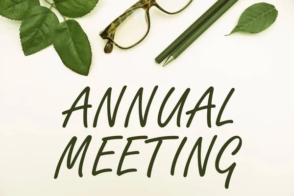 Text sign showing Annual Meeting. Business overview Yearly gathering of an organization interested shareholders Office Supplies Over Desk With Keyboard And Glasses And Coffee Cup For Working