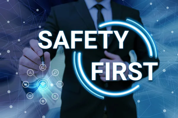 Inspiration showing sign Safety First. Business approach Avoid any unnecessary risk Live Safely Be Careful Pay attention Man holding Screen Of Mobile Phone Showing The Futuristic Technology. —  Fotos de Stock