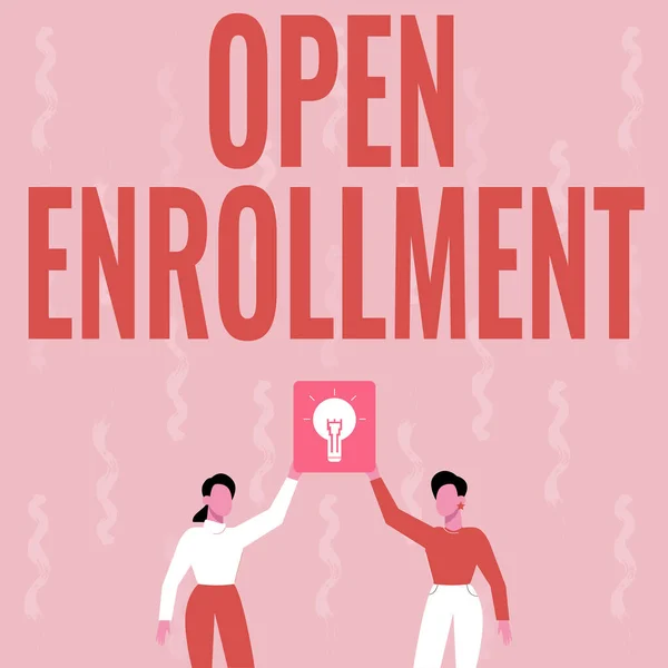 Conceptual caption Open Enrollment. Word for The yearly period when showing can enroll an insurance Two Colleagues Holding Lamp Presenting New Achievement Reached. — ストック写真