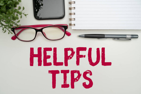 Text showing inspiration Helpful Tips. Business concept Useful secret Information Advice given to accomplish something Office Supplies Over Desk With Keyboard And Glasses And Coffee Cup For Working