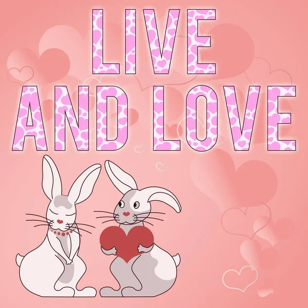 Text showing inspiration LIVE AND LOVE. Business concept Couple in love living with each other Bunnies with heart shaped gifts demonstrate passionate lovers with presents — Stockfoto