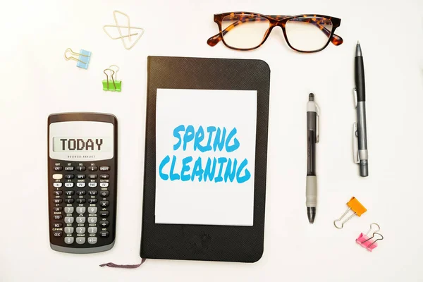 Conceptual caption Spring Cleaning. Business approach practice of thoroughly cleaning house in the springtime Office Supplies Over Desk With Keyboard And Glasses And Coffee Cup For Working — Stock Photo, Image