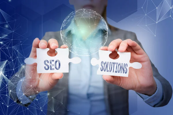 Writing displaying text Seo Solutions. Business idea Search Engine Result Page Increase Visitors by Rankings Lady in suit holding puzzle piece symbolizing global innovative thinking. — Foto Stock