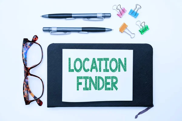 Text sign showing Location Finder. Conceptual photo A service featured to find the address of a selected place Office Supplies Over Desk With Keyboard And Glasses And Coffee Cup For Working — Fotografia de Stock